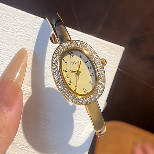 Gold-tone oval case bracelet watch with decorative dial