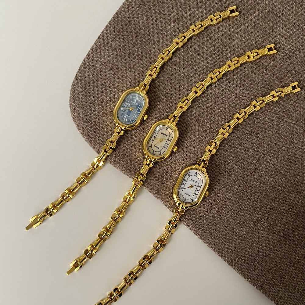 Mother-of-pearl oval bracelet watch with a gold chain for a mature Christmas gift for mom